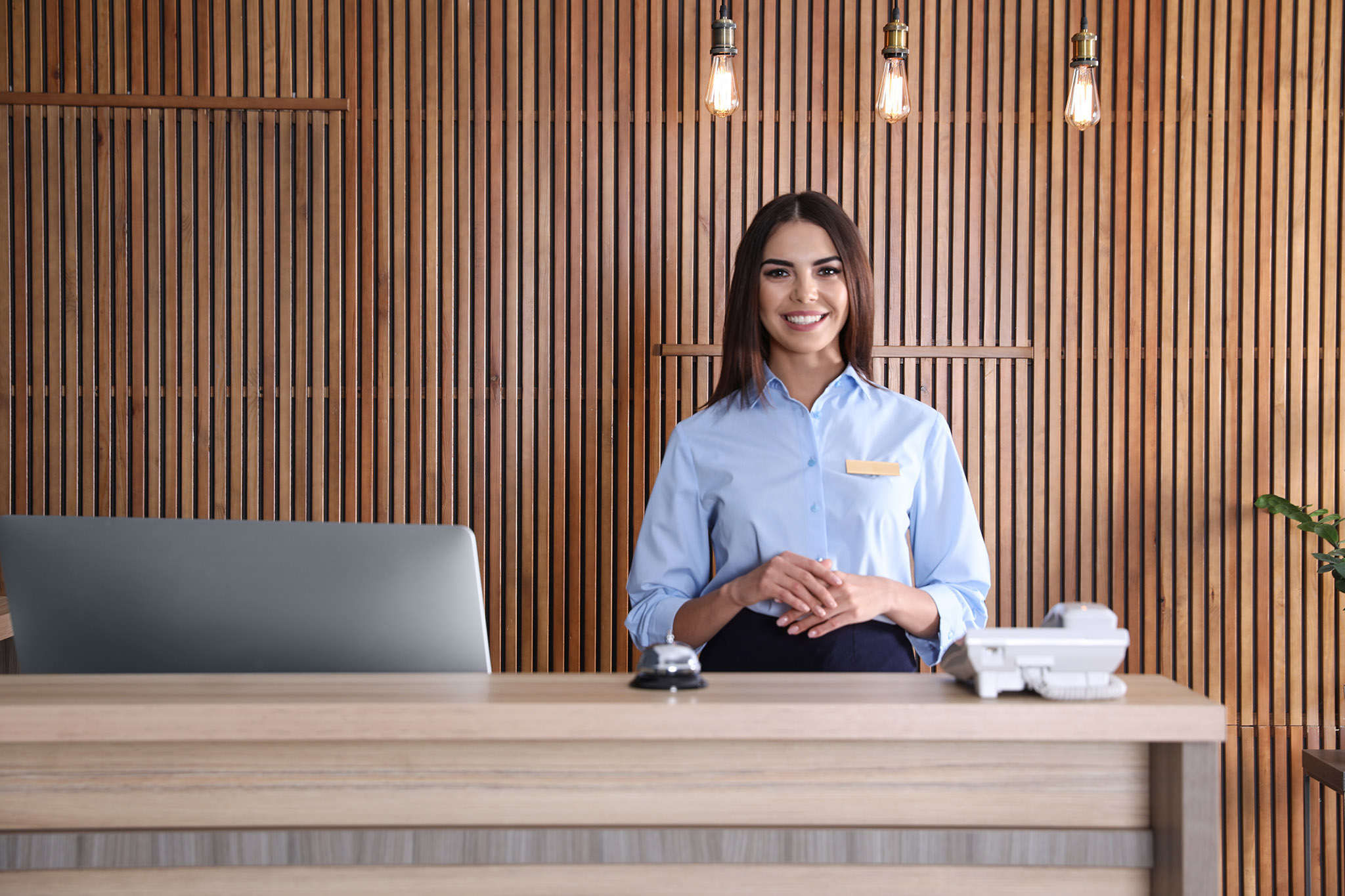 Portrait,Of,Receptionist,At,Desk,In,Lobby